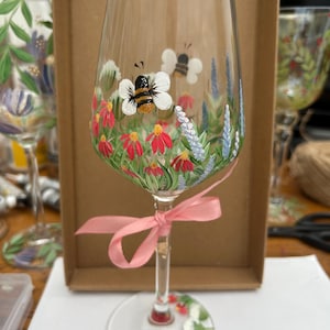 Hand painted buzzy bee and wild flower wine glass