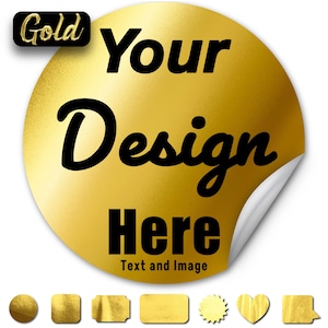 May include: A gold foil sticker with the text "Your Design Here" in black. The sticker has a peel-off corner and a "Gold" label in the upper left corner. Several gold foil shapes are shown below the sticker.
