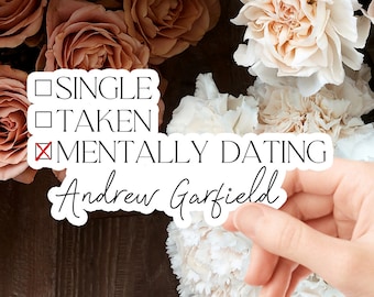 May include: A white sticker with a checklist that says "Single", "Taken", and "Mentally Dating" with a red X next to "Mentally Dating". The sticker also has the name "Andrew Garfield" written in cursive.