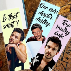 May include: Three rectangular bookmarks featuring images of a man. The first bookmark has the text "Is that smut?" on a yellow background. The second bookmark has the text "One more chapter, darling." on a light blue background. The third bookmark has the text "Keep reading babe." on a pink background.