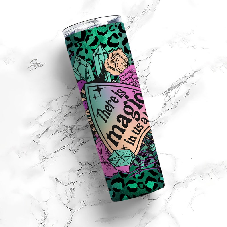 May include: A green and black stainless steel tumbler with a leopard print design. The tumbler features a pink and purple graphic with the text "There is magic in us all".