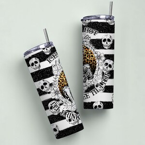 May include: Two black and white striped stainless steel tumblers with a skull and crossbones design. One tumbler says "I'll Drink Coffee Till I'm Hot" and the other says "Hot Coffee Lot".