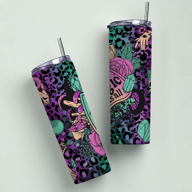 May include: Two stainless steel tumblers with lids and straws. Both tumblers feature a black and purple leopard print background with a variety of colorful designs including flowers, crystals, and a hand with an eye. One tumbler has the text "Magic is all around" on it.