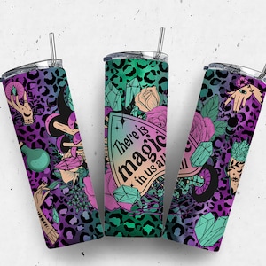 May include: Three stainless steel tumblers with a colorful, magical design. The tumblers feature a leopard print background with crystals, flowers, and hands with magical symbols. The text on the tumbler reads "There is magic in us all".