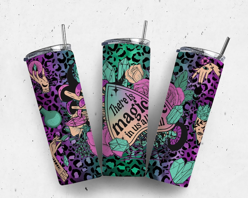 May include: Three stainless steel tumblers with a colorful, magical design. The tumblers feature a leopard print background with crystals, flowers, and hands with magical symbols. The text on the tumbler reads "There is magic in us all".
