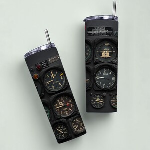 May include: Two black stainless steel tumblers with a vintage airplane instrument panel design. Each tumbler features a variety of gauges, dials, and the text "WARNING CRITICAL MACH NO. 8". Includes a black and white striped straw.