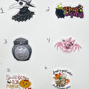 May include: A collection of Halloween-themed stickers. Includes a plague doctor, a cauldron with the text "Hocus Pocus", a jar labeled "Deadly Night Shade", a pink bat, a pumpkin with the text "Sweeter than Pumpkin Spice", and a coffee cup with the text "Just a girl who loves pumpkin spice".