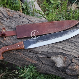 May include: A large, curved, black blade with a brown wooden handle and a brown leather sheath. The blade is sharpened on one side and has a slight curve. The handle is made of wood and has a slight curve. The sheath is made of leather and has a flap that closes with a snap.