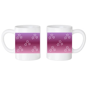 May include: Two white ceramic mugs with a pink to purple ombre design and white star outlines.