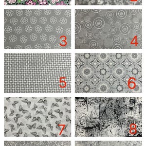 May include: A collage of ten fabric swatches featuring various patterns: pink and black flowers on green, white botanical sketches on grey, white flower outlines on grey, white dotted circles on grey, a grey grid, grey geometric tiles, black butterflies on white, black abstract splatters on white, grey swirls, and a grey speckled texture.