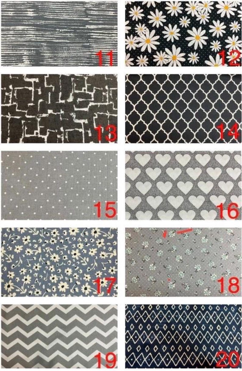 May include: A collection of ten fabric swatches featuring various patterns including horizontal lines, white daisies on black, geometric blocks, quatrefoil, white polka dots, white hearts, small floral prints, grey chevrons, and white diamonds on navy.