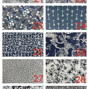 May include: A grid of ten fabric swatches labelled 21 through 30, featuring patterns including nautical maps, blue and white floral prints, arrows, anchors, grey polka dots, black and white paint splatters, and a dense white daisy floral pattern.