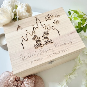 May include: A wooden box featuring a Mickey Mouse and Minnie Mouse design. The box is engraved with "Hollie's Disney Memories, Florida - October 2023".