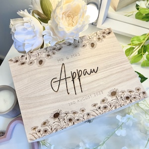 May include: A wooden box with a floral design and the text "MR & MRS Appan 3RD AUGUST 2022" engraved on the lid.