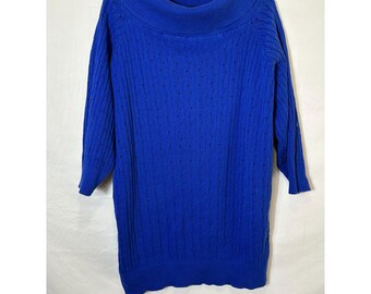 May include: A cobalt blue sweater dress with a wide cowl neck and three-quarter sleeves. The knitwear features a textured pattern with small eyelet details. The dress is hanging on a black hanger against a white background.