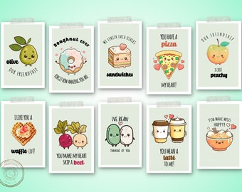 May include: A set of ten rectangular greeting cards featuring cute, anthropomorphic food illustrations with puns. Designs include an olive, donut, sandwich, pizza slice, peach, waffle, beet, bean, coffee cups, and miso soup, all with text captions.