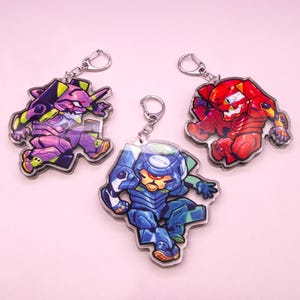 May include: Three anime-style keychains featuring colorful robot characters. The keychains are made of clear acrylic and have silver-colored metal key rings. The robots are in shades of purple, red, and blue, with detailed designs and dynamic poses.