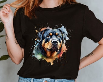 May include: A black t-shirt with a watercolor illustration of a Rottweiler dog's head. The illustration features splashes of colorful paint.
