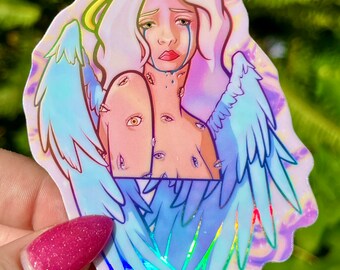 May include: A sticker of an angel with blue wings and a halo. The angel has a sad expression and is crying. The angel's body is covered in eyes.