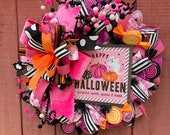 Unique large pink and orange Halloween wreath. Decorative wreath with pumpkins, sweets, spooks and treats, Handmade Halloween candy.
