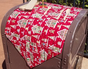 May include: A red and white gingerbread themed table runner with a gold candle holder and wooden cutlery. The runner is draped over a brown metal trash can. The background shows a lake and a sign that says "EPCOT 40".