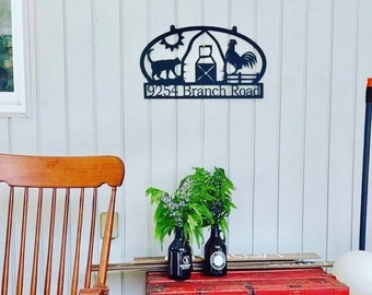 May include: Black metal farmhouse sign with a barn, rooster, cat, and sun design. The sign reads "9254 Branch Road".