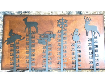 May include: A set of five metal snow depth gauges with different winter-themed silhouettes. The gauges are marked with numbers from 6 to 24. The silhouettes include a snowmobile, a truck with a plow, a snowflake, a snowman, and a deer.