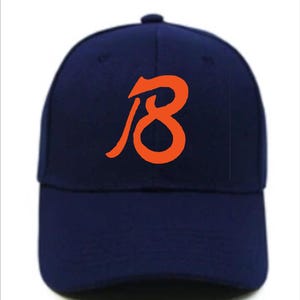May include: A navy blue baseball cap with an orange stylised number "18" on the front.