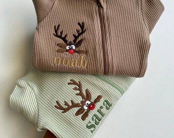 May include: Two brown and green baby onesies with a reindeer design and the names "noah" and "sara" embroidered on them.