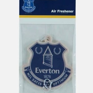 May include: A white car air freshener with a blue and white Everton Football Club crest. The crest features a tower, two wreaths, and the text "Everton 1878 Nil Satis Nisi Optimum".