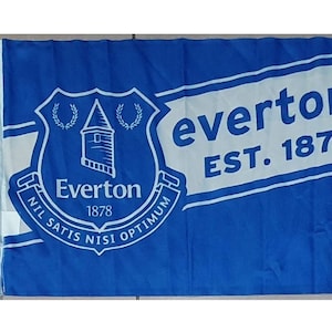 Puede incluir: Una bandera azul y blanca con el escudo del Everton Football Club y el texto "Everton EST. 1878". El escudo presenta una torre, una corona y el texto "Everton 1878 NIL SATIS NISI OPTIMUM".