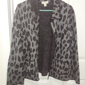 May include: A gray and brown leopard print cardigan with a button closure. The cardigan has two pockets and a collar. The label reads "Style & Co."