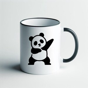 May include: White ceramic mug with a black rim, handle, and a black and white panda bear graphic. The panda is in a dabbing pose. The mug is a standard size for tea or coffee.
