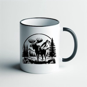 May include: White ceramic mug with a black handle and a black silhouette of a moose standing in a forest scene with mountains in the background.