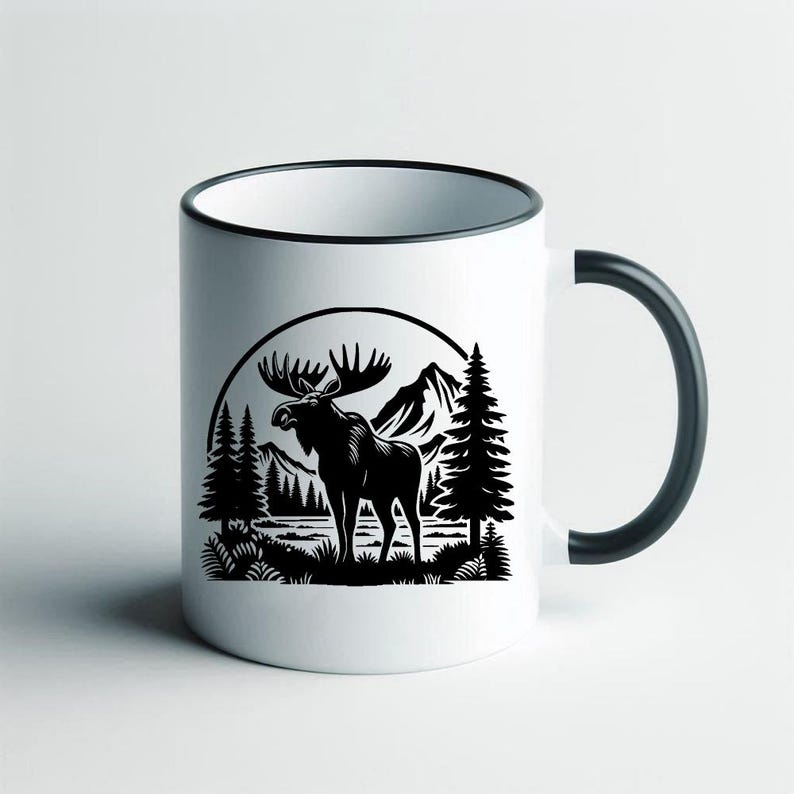 May include: White ceramic mug with a black handle and a black silhouette of a moose standing in a forest scene with mountains in the background.