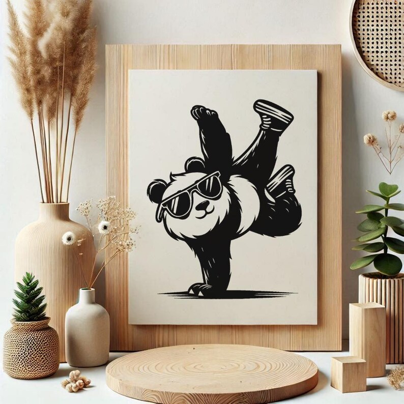 May include: A black and white illustration of a panda wearing sunglasses, performing a handstand. The panda is set against a cream background, framed in light wood. The image is surrounded by decorative vases, plants, and wooden accents.