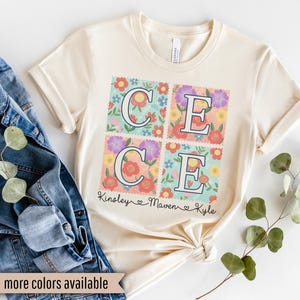 May include: Cream-colored t-shirt with the name "CECE" in a floral design. The design is composed of four squares with the letters C and E, surrounded by colorful flowers. The names Kinsley, Maven, and Kyle are written below.