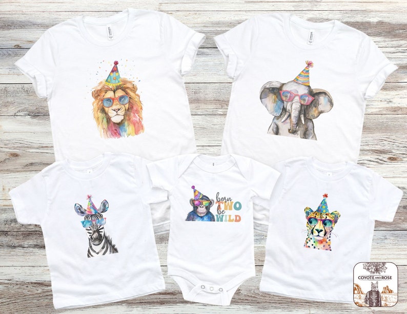May include: Set of five white t-shirts featuring watercolour illustrations of animals wearing party hats and sunglasses. The shirts have the text "born to be wild" on one of the shirts.