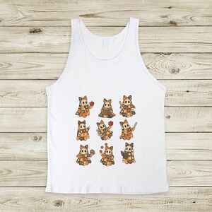May include: White tank top featuring a repeating pattern of cartoon characters with orange and brown patchwork outfits, each holding an apple or other items. The design is centered on the front of the sleeveless shirt.
