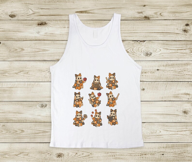 May include: White tank top featuring a repeating pattern of cartoon characters with orange and brown patchwork outfits, each holding an apple or other items. The design is centered on the front of the sleeveless shirt.