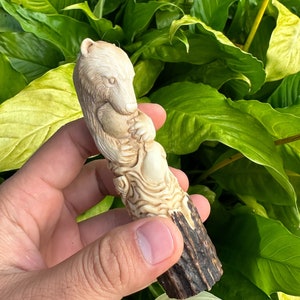 Antler carving - carved bear and fish for knife handles.
