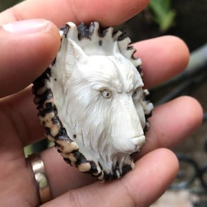 Antler carving wolf for pendant.
