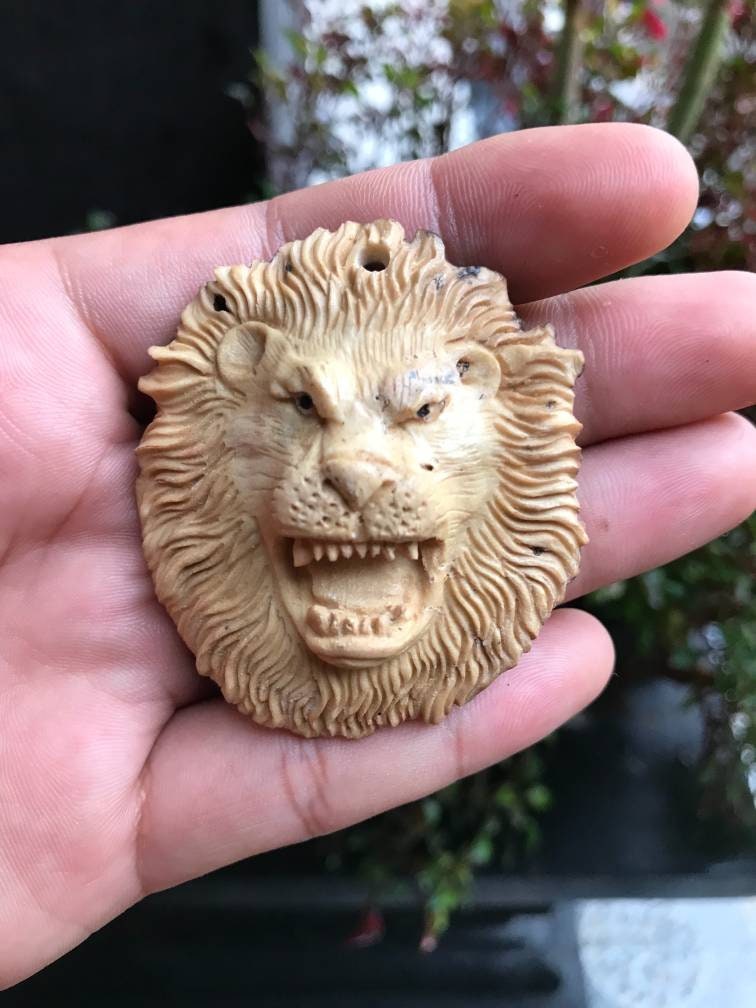 Antler carving, Carved pendant face lion from deer antler.