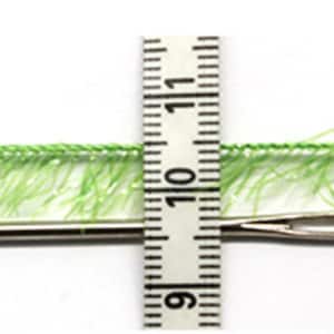 May include: A green fuzzy trim with a needle measuring approximately 1 inch (2.5 cm) in length. The trim is about 12 mm wide.