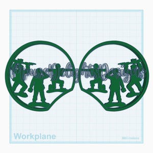 May include: Two green silhouette designs of toy soldiers inside a circular frame. The text "Mousey Jelly Designs" is inside the circle. The design is on a white and blue grid background.