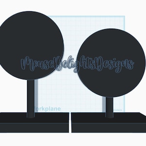 May include: Two black display stands with circular tops and rectangular bases. The stands have a minimalist design, suitable for showcasing jewelry or small items. The text "MouseDelightsDesigns" is visible on the image.
