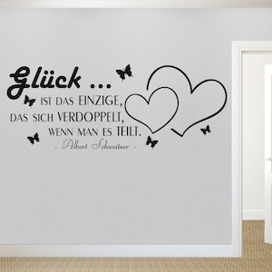 May include: Black and white wall decal with two hearts and butterflies. The decal features the quote "Glück... IST DAS EINZIGE, DAS SICH VERDOPPELT, WENN MAN ES TEILT. - Albert Schweitzer -"