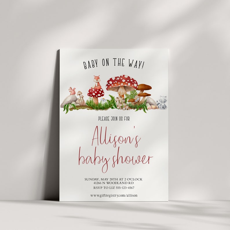 May include: A baby shower invitation with a woodland theme. The invitation features a red and white mushroom, a fox, a squirrel, and a raccoon. The text on the invitation reads "Baby on the Way!" and "Allison's baby shower". The invitation also includes the date, time, location, and RSVP information.