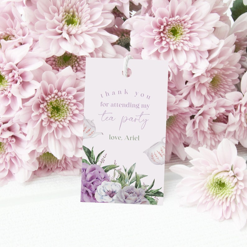 May include: A pink and white thank you tag with a floral design and the text "thank you for attending my tea party love, Ariel".