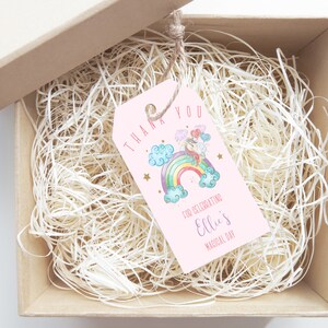 May include: Pink thank you tag with a unicorn riding a rainbow, clouds, and stars. The text reads "Thank You for celebrating Ellie's Magical Day."